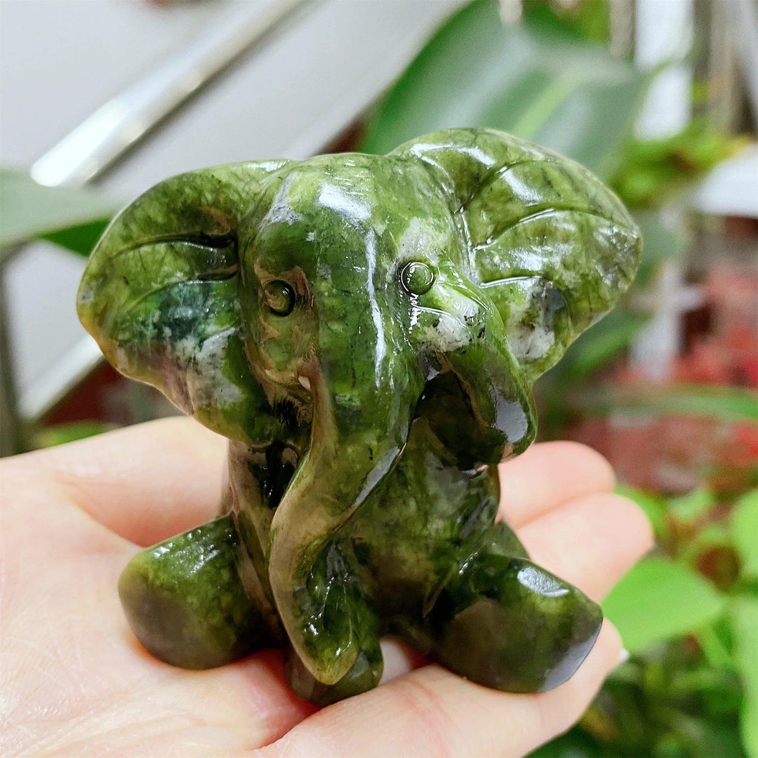 Hand-carved Xiuyan Jade elephant figurine in deep forest green, offering grounding energy and Heart Chakra healing.