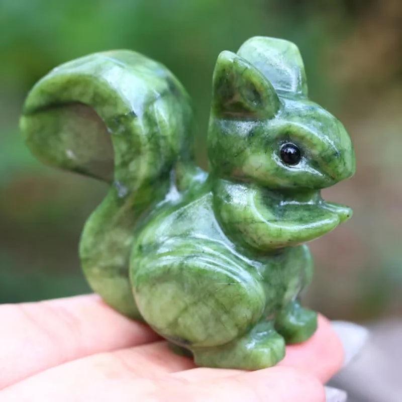 Hand-carved Xiuyan Jade squirrel figurine with a polished, waxy green luster for grounding and heart chakra healing.