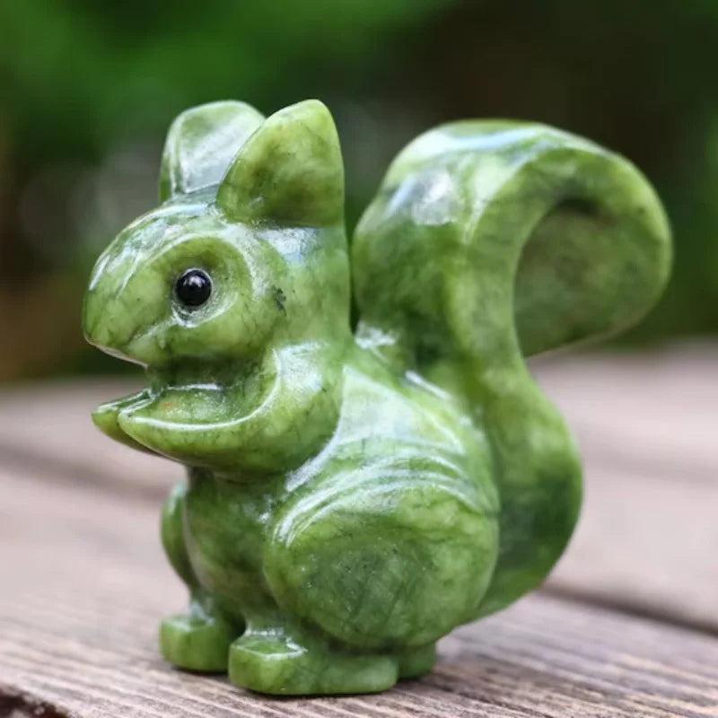 Hand-carved Xiuyan Jade squirrel figurine with a polished, waxy green finish for grounding and Heart Chakra healing.