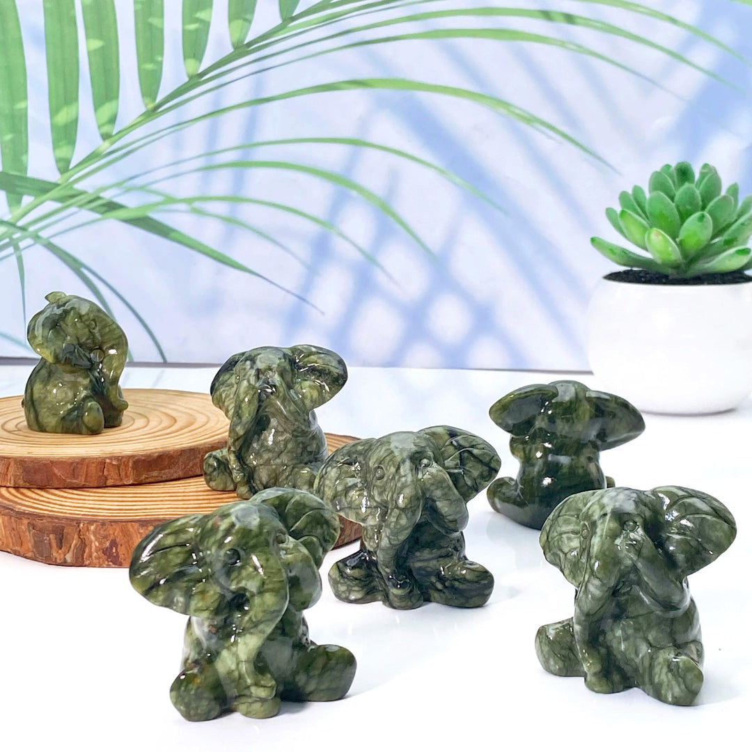 Xiuyan Jade Crystal Carved Elephant Statues: Deep green, waxy jade elephants symbolizing luck, wisdom, and protection.