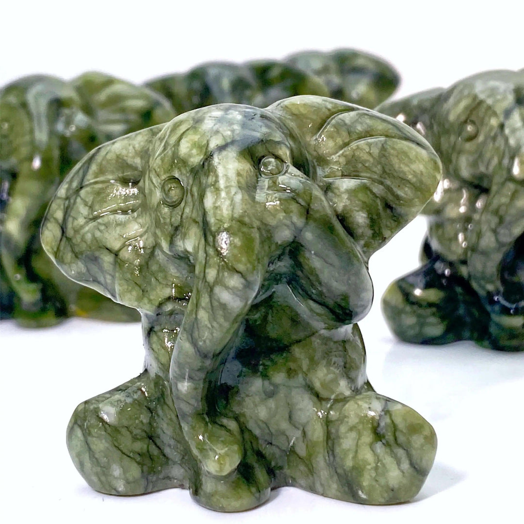 Deep green Xiuyan Jade elephant carving, symbolizing wisdom, luck, and protection.
