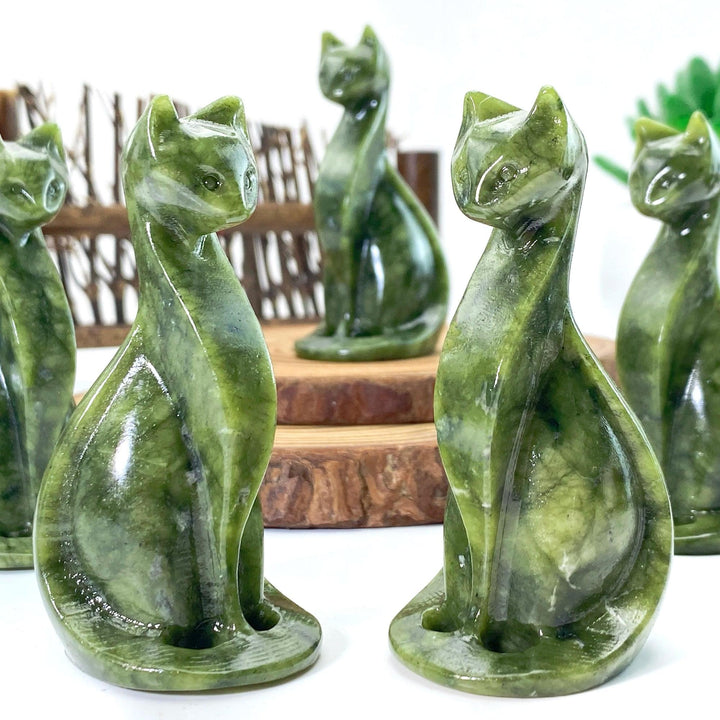Polished Xiuyan jade Egyptian cat carvings, deep green with natural variations, ideal for home decor or gifts.