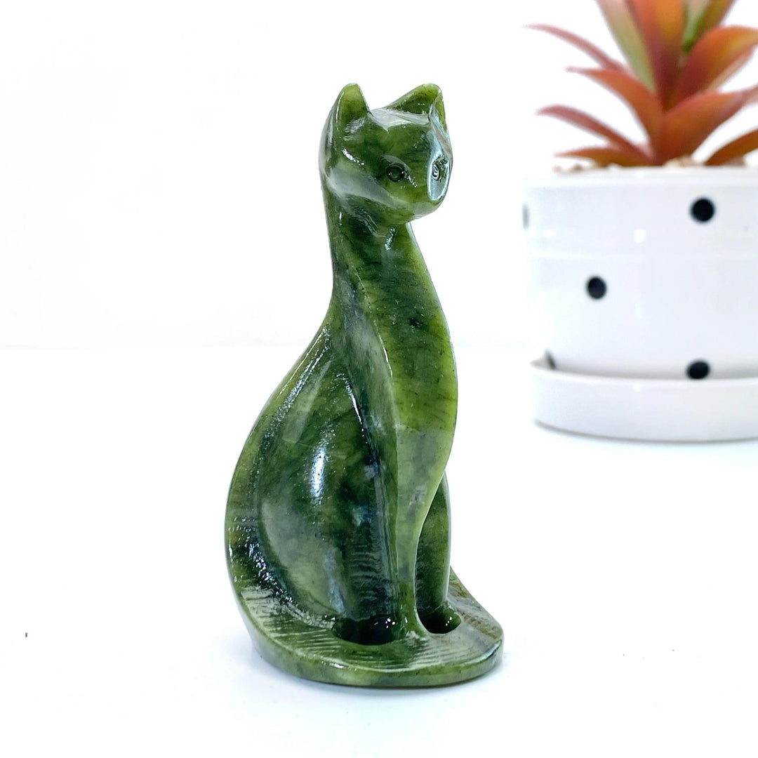 Polished Xiuyan jade Egyptian cat carving, dark green crystal, for home decor or gift.