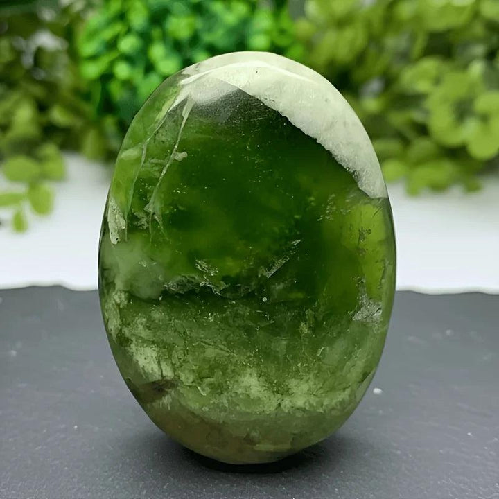 Polished green Xiuyu Palmstone crystal with natural white inclusions for healing and home decor.