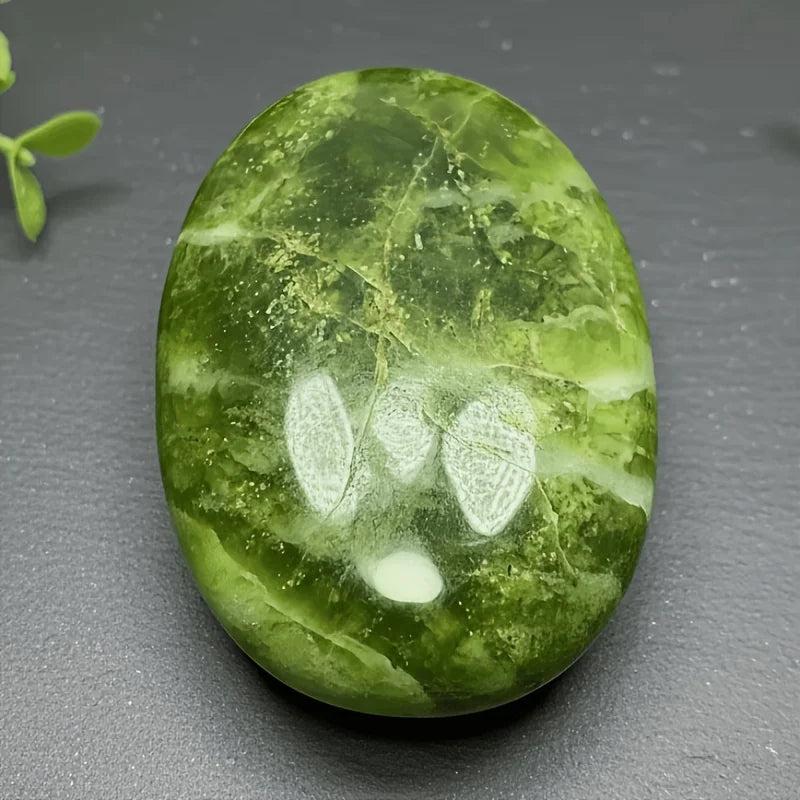Polished green Xiuyu palmstone crystal with natural white veining for healing and boho decor.