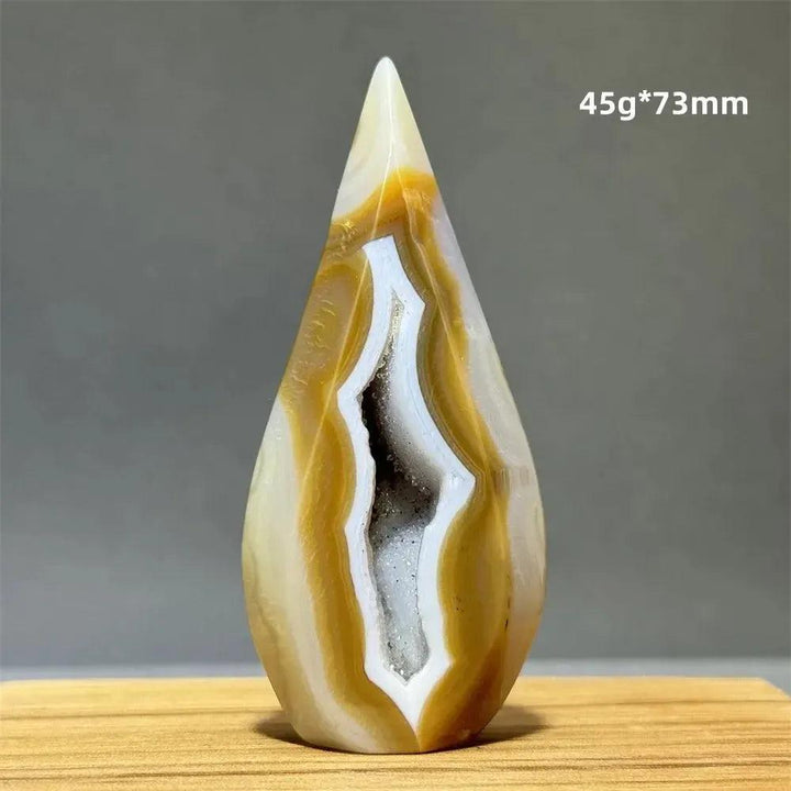 Yellow Agate Freeform Cave Torch from Crystal Destiny. Natural banded mineral specimen with a white geode interior.