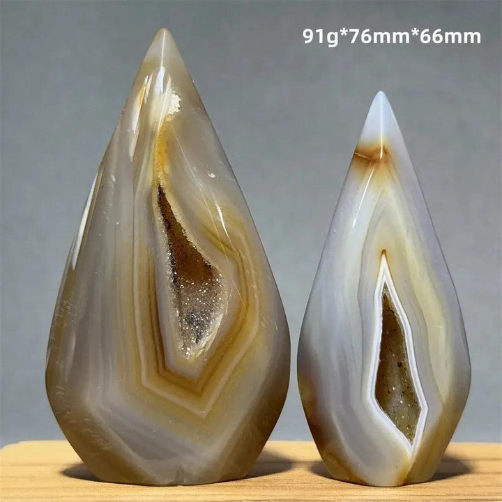 Two teardrop-shaped Yellow Agate freeform cave torches with sparkling crystal interiors from Crystal Destiny.
