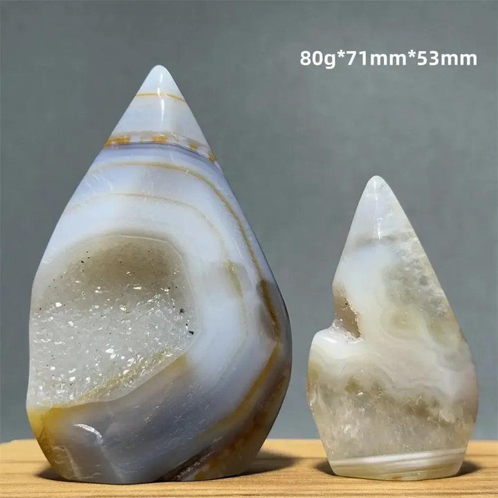 Two natural yellow agate freeform cave torch specimens from Crystal Destiny, showcasing banded layers and sparkling druzy.