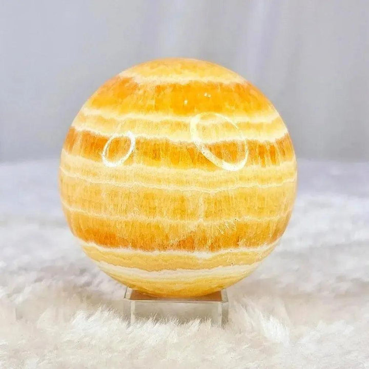 Polished Yellow Calcite Honey Calcite Sphere radiating warm honey-golden tones with natural banding, boosting confidence.