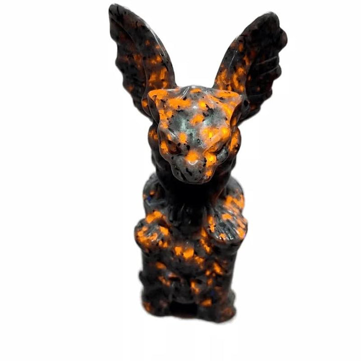 UV reactive Yooperlite gargoyle statue, dark gray with vivid orange glowing spots, for protection and intuition.