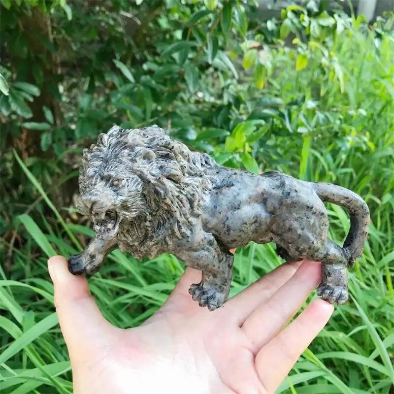 Hand-carved Yooperlite lion statue in polished grey-green stone, a UV-reactive crystal for Solar Plexus chakra energy.