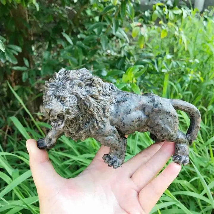 Hand-carved Yooperlite lion statue in polished grey-green stone, a UV-reactive crystal for Solar Plexus chakra energy.