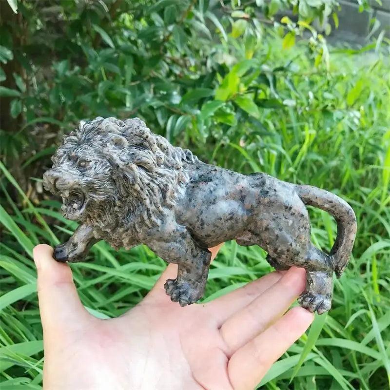 Hand-carved Yooperlite lion statue in mottled grey-green, a 160mm UV-reactive crystal for Solar Plexus chakra energy.