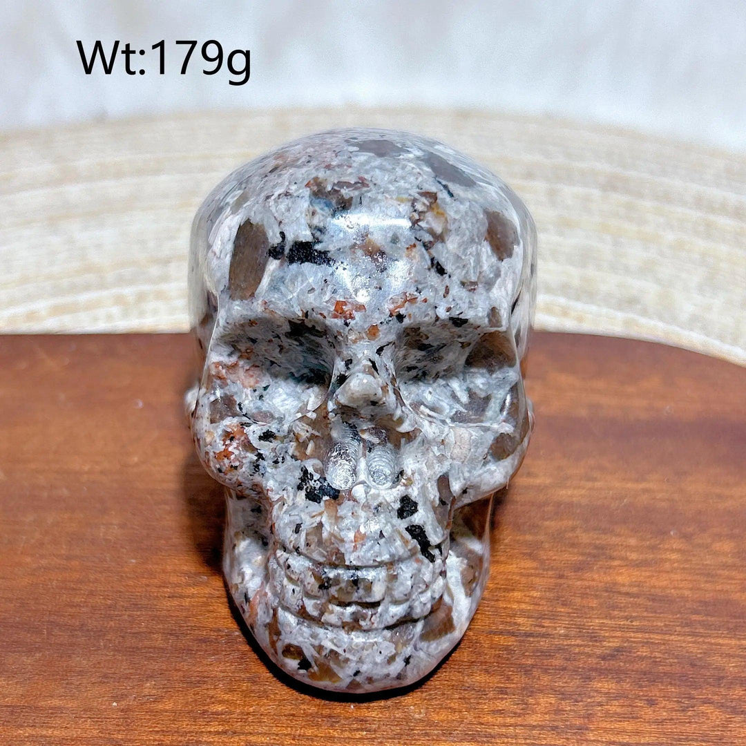 Yooperlite Crystal Carved Skull, a beautifully detailed grey stone with orange and black flecks, weighing 179g.