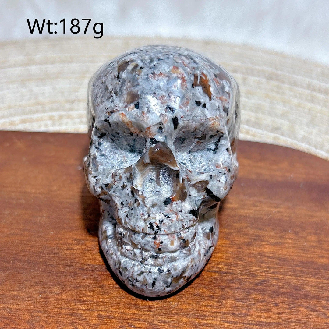 Yooperlite Crystal Carved Skull, a detailed grey stone with orange and black flecks, for protection and grounding.