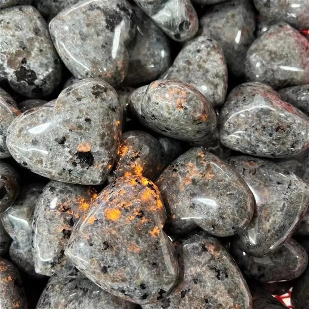 Yooperlite Crystal Heart Stone UV Reactive: Grey and white pebbles with vivid orange glow under UV light. Supports Third Eye, Root, Sacral chakras.