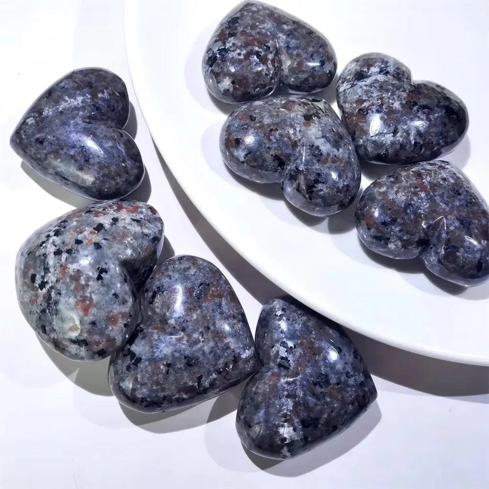 Yooperlite Crystal Heart Stone UV Reactive: Polished grey and white heart-shaped stones with dark flecks.