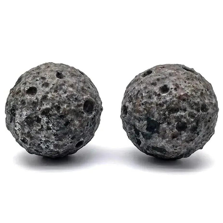 Two textured Yooperlite moon spheres with a cratered, volcanic grey surface for Reiki healing and spiritual energy.