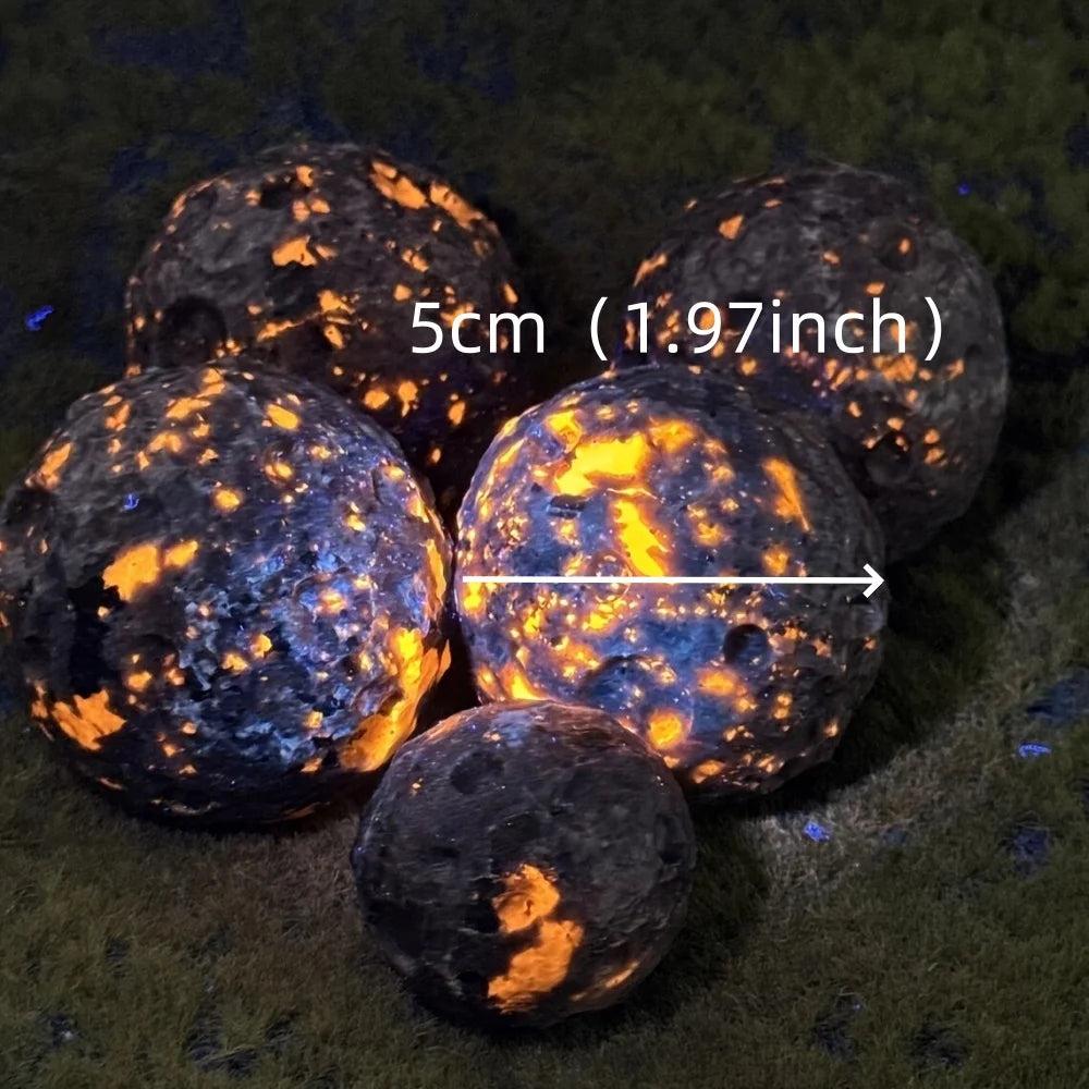 Yooperlite Crystal Sphere UV Reactive Glowing Moon Ball, five dark spheres with vivid orange and gold glowing patterns.