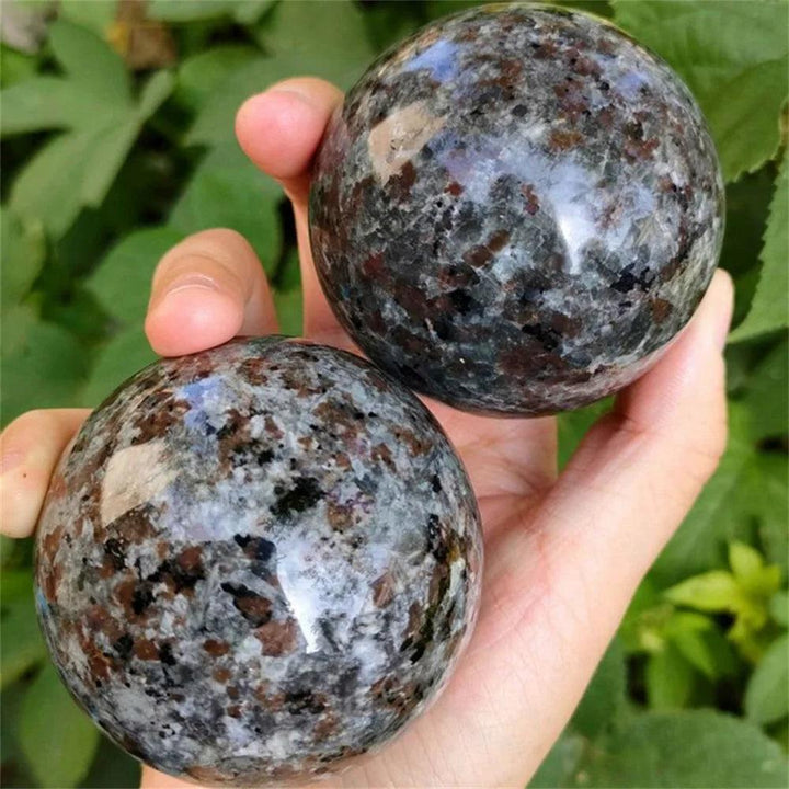 Two polished Yooperlite crystal spheres with grey and brown mottled patterns, perfect for grounding and stability.