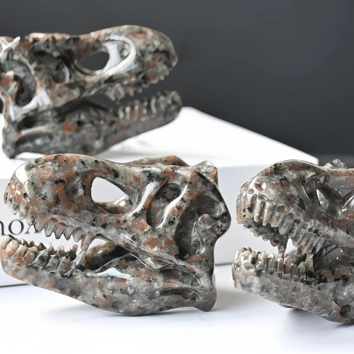Yooperlite T-Rex skull carving, brown and gray with orange flecks, UV reactive, for protection and grounding.