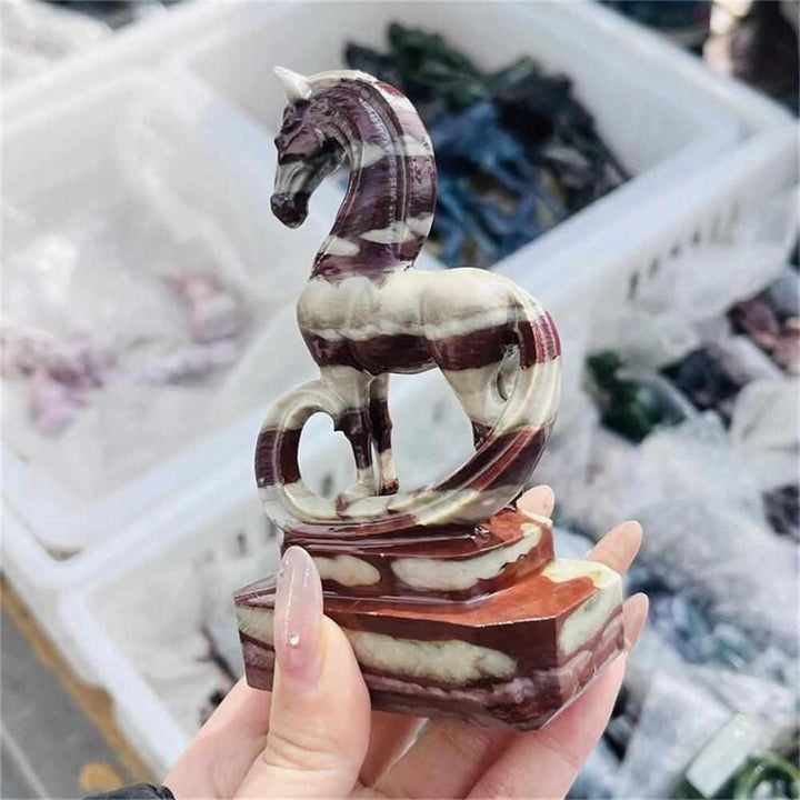 Hand-carved Zebra Stone horse sculpture with striking black and cream stripes for grounding Root Chakra energy.