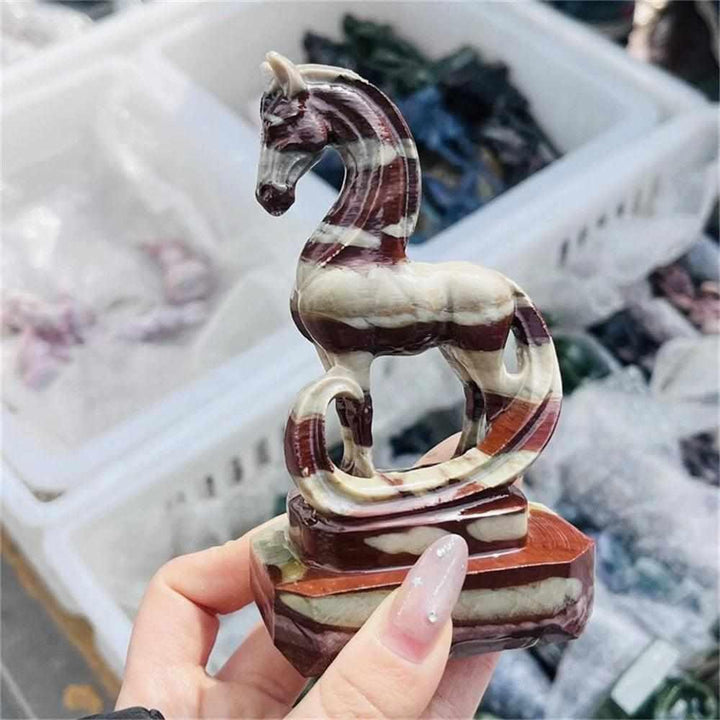 Hand-carved Zebra Stone horse sculpture featuring striking black and white banded patterns for grounding energy.