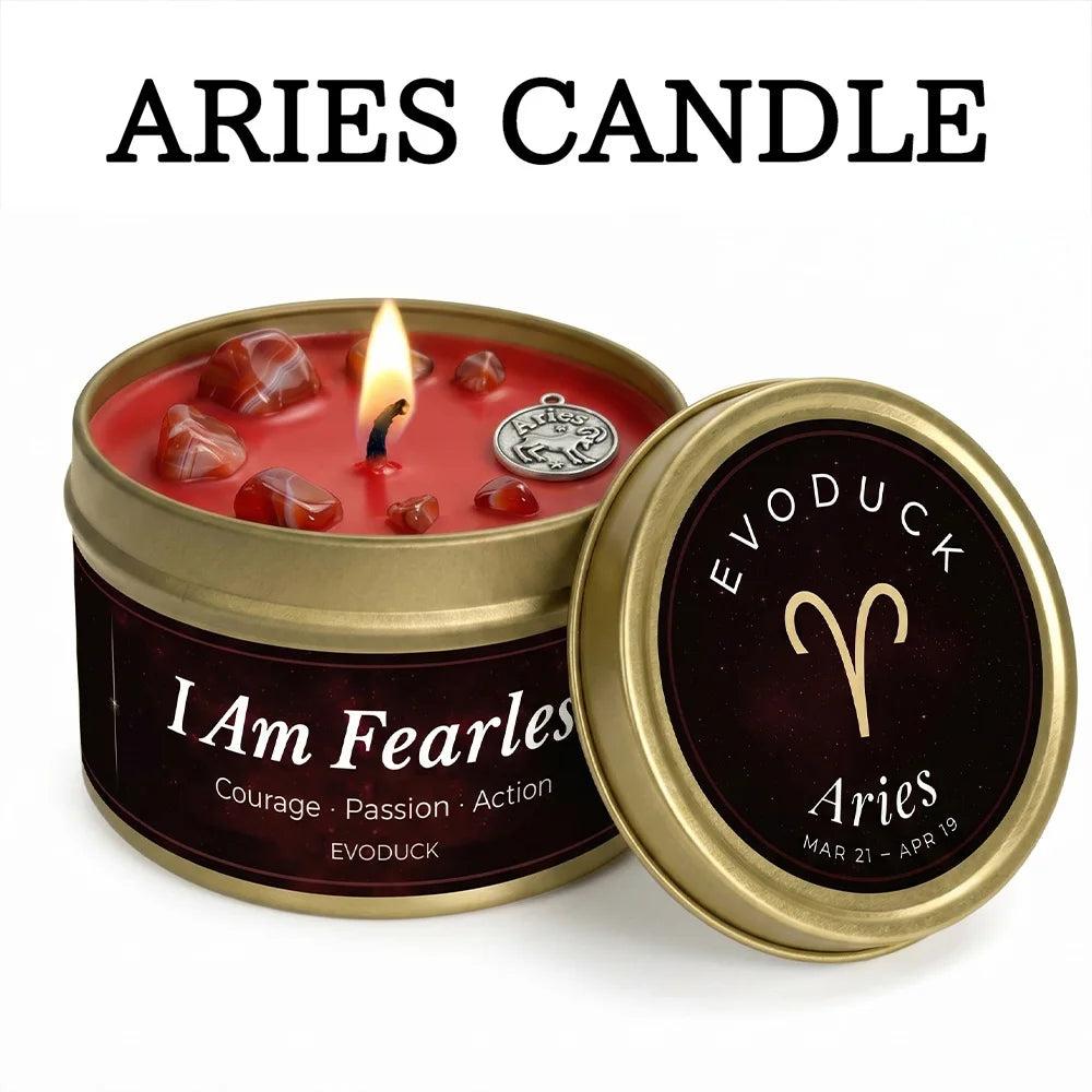 Aries Crystal Infused Candle with red Carnelian stones, a lit wick, and a gold tin.