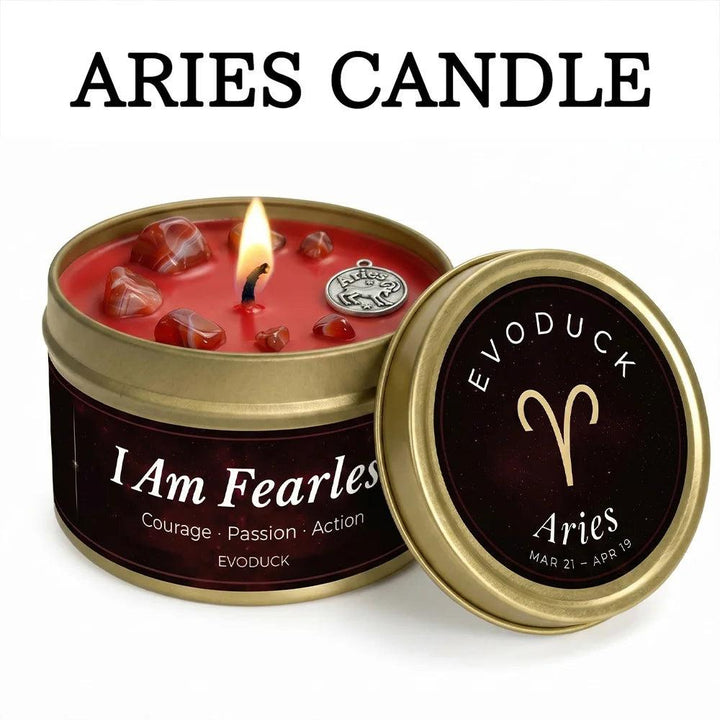 Aries Crystal Infused Candle with red Carnelian stones, a lit wick, and a gold tin.
