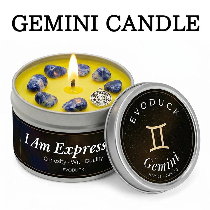 Gemini Crystal Infused Candle with Sodalite stones, a silver zodiac charm, and a lit wick in a tin.