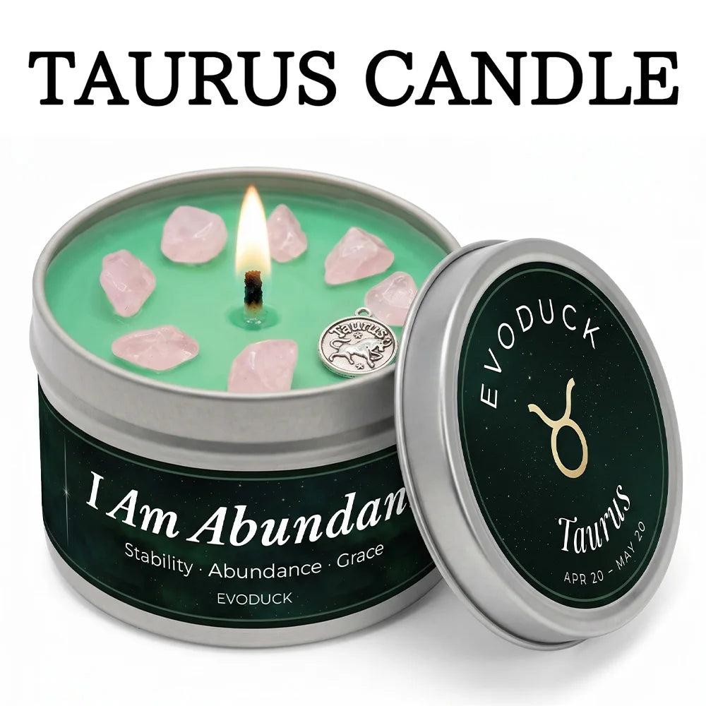 Taurus Crystal Infused Candle with rose quartz, a lit wick, and "I Am Abundant" on a green tin.
