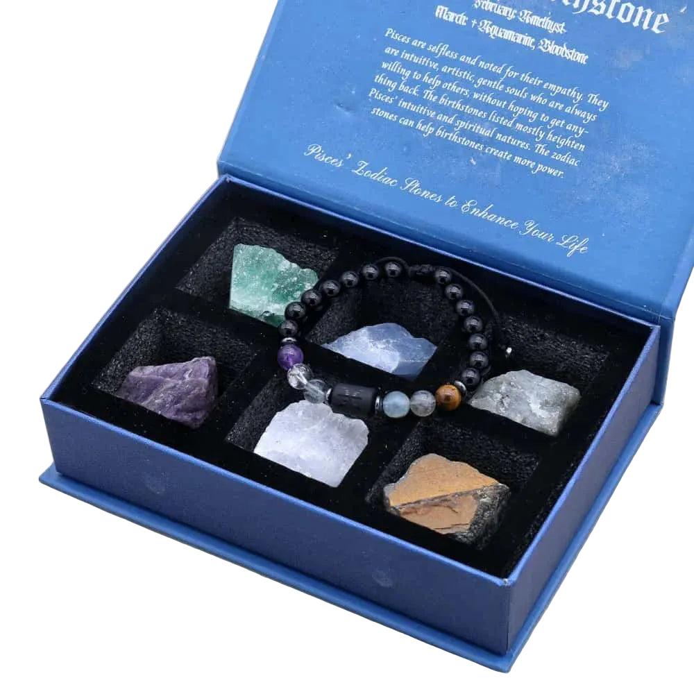 Blue velvet-lined Zodiac gift box with Lapis Lazuli and Amethyst crystal bracelet, raw stones, and Pisces description.