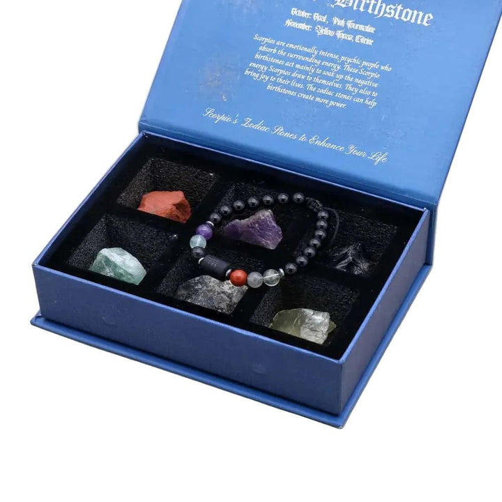 Zodiac Crystals & Bracelet gift set with Lapis Lazuli, Amethyst, and raw stones in a velvet-lined blue box.