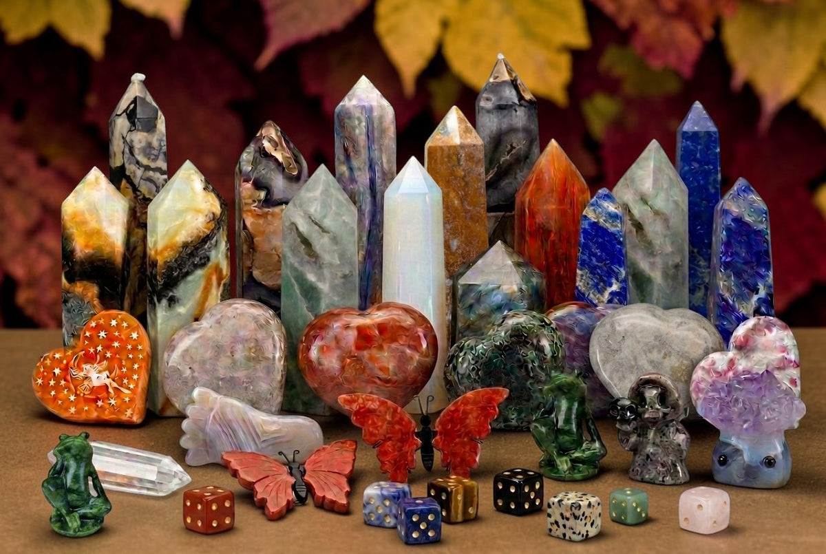 Collection of vibrant crystal towers, carved hearts, butterfly figures, and novelty frogs for healing and decor.
